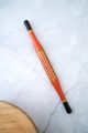 Orange and black rolling pin art piece